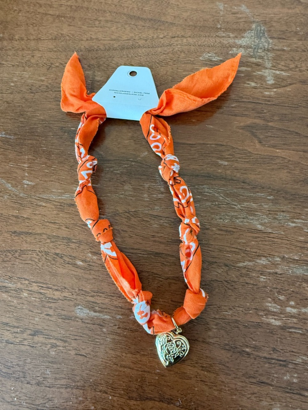 Orange Fabric Knot Necklace with Gold Heart Pendant by Nickel and Suede